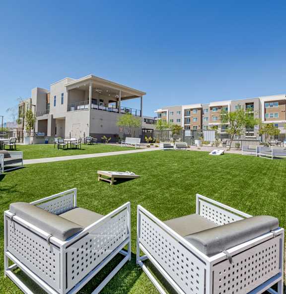 Lawn with yard games and seating at Element 12 pet-friendly apartments in Henderson, NV