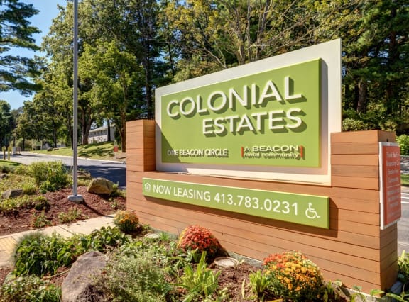 a sign for colonial estates on the side of a road at Colonial Estates Apartments, Springfield, Massachusetts