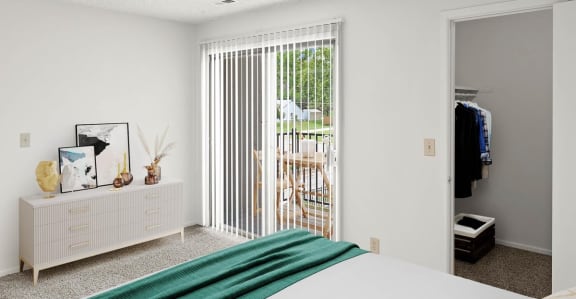 a bedroom with white walls and a green blanket on the bed