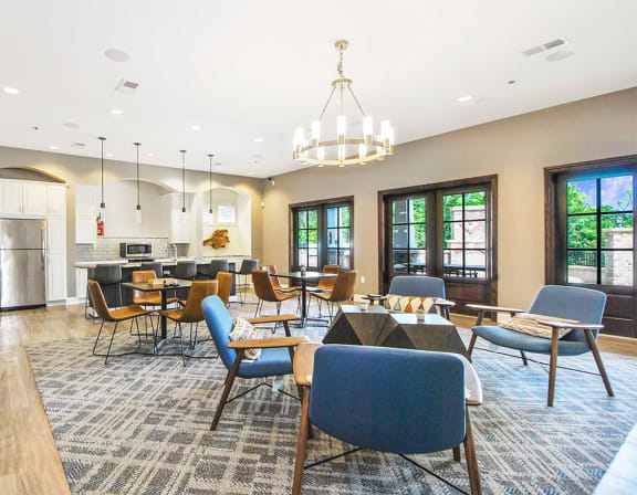 the reserve at bucklin hill clubhouse with tables and chairs and a kitchen in the background