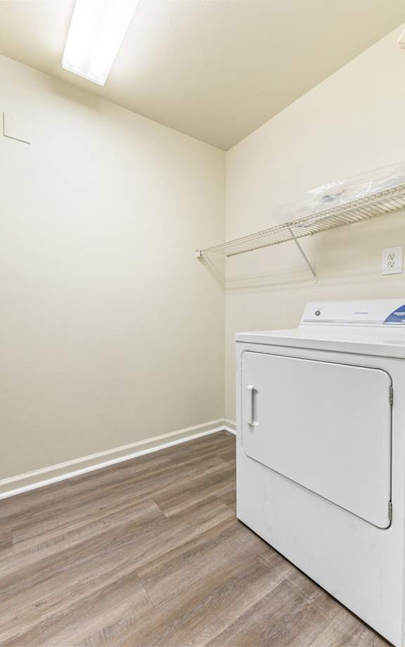 A white washing machine in a small laundry room. at Northampton Village Apartments, Indianapolis, Indiana