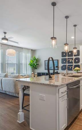 A modern kitchen with a large island and stainless steel appliances.