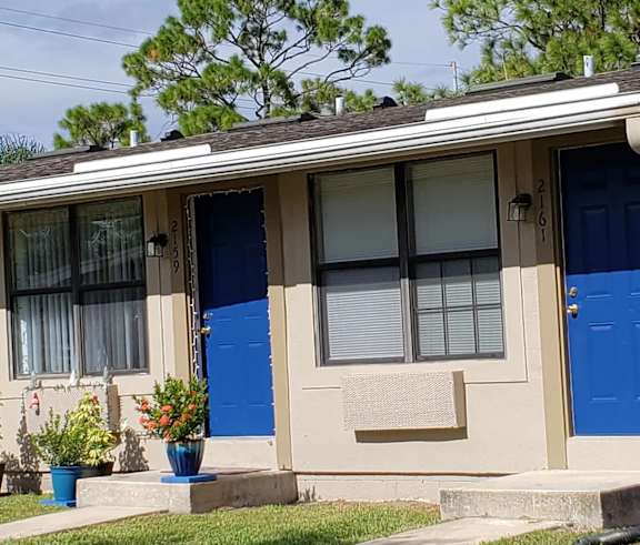 a house with two blue doors and a window