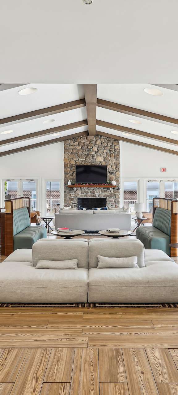 A spacious living room with a fireplace and a large couch.