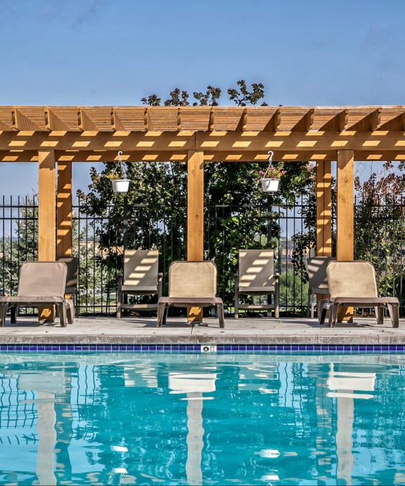 a pergola by the pool at the west end lodge apartments in beaumont