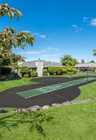 A green and black striped pathway leads to a building.