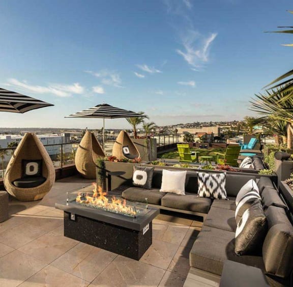 Outdoor Fireplace and Seating Area at AV8 Apartments in San Diego, CA