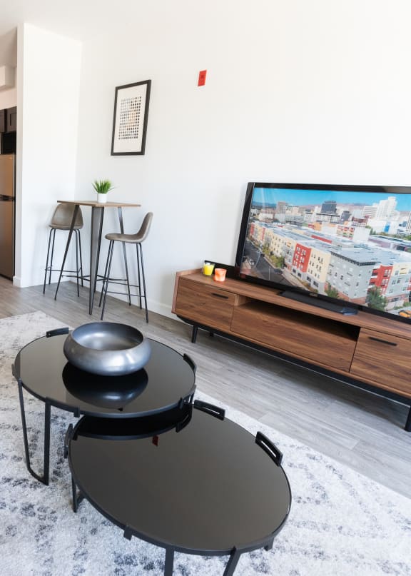 a living room with a large tv and a couch  at ParcOne60, Reno, 89501
