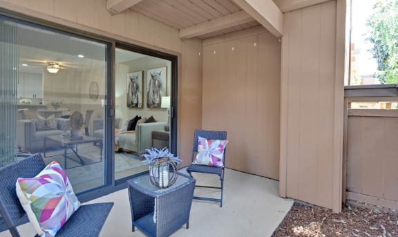 a patio with two chairs and a table