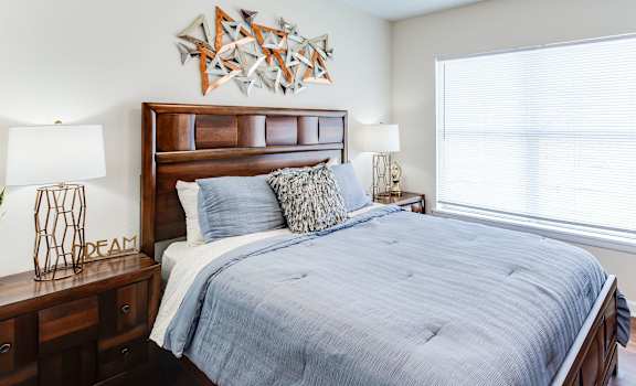a bedroom with a large bed and a large window