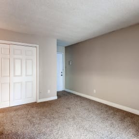 a bedroom with a white door and carpet