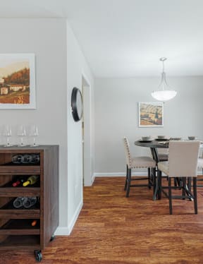 a kitchen with white cabinets and black appliances