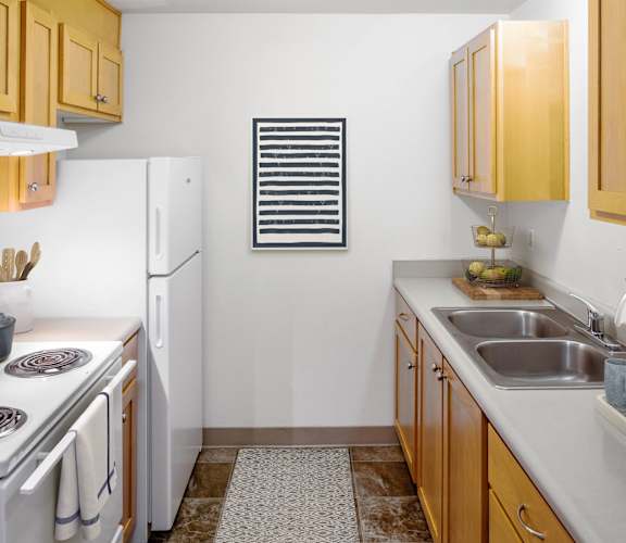 a kitchen with white appliances and wooden cabinets
