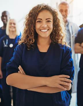 A group of medical professionals are standing together in a bright room.