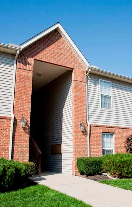 A building with a blue door and a white garage door.