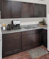 a kitchen with white appliances and brown cabinets and a refrigerator