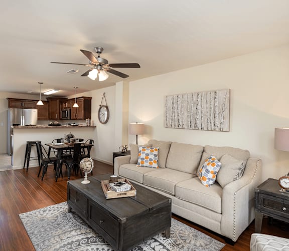a living room and kitchen with a dining table