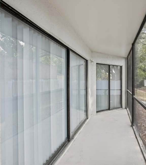 A long hallway with glass doors and windows.
