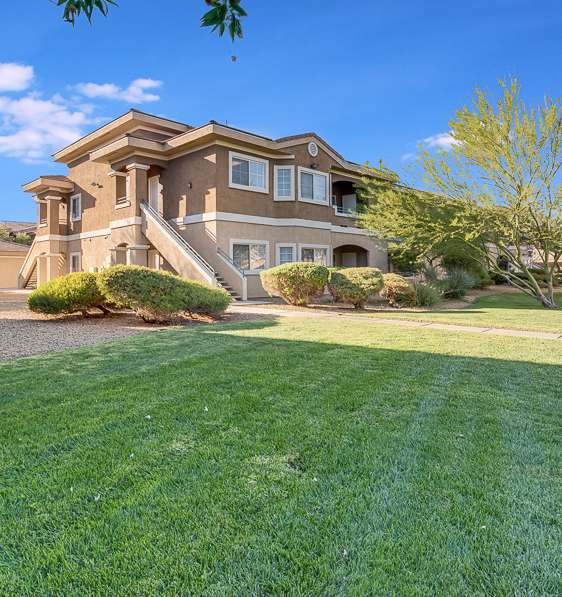 A house with a well-manicured lawn in front of it.