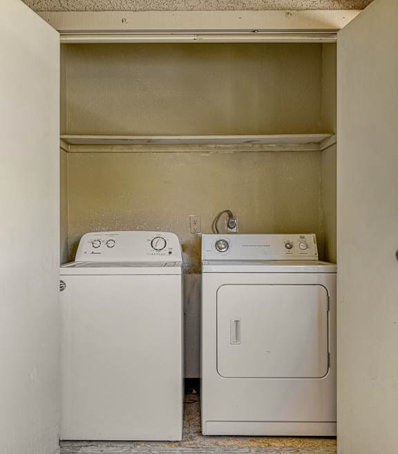 A small laundry room with a washer and dryer.