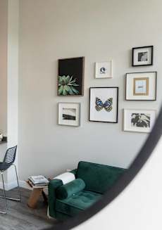 a view of a living room and a kitchen through a mirror