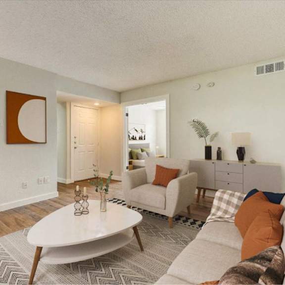 A living room with a white couch and a coffee table.