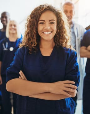 a group of nurses standing together with their arms crossed