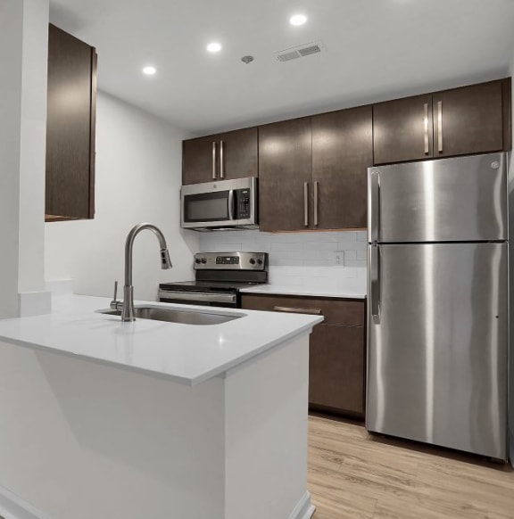 a kitchen with a white counter top and a stainless steel refrigeratorat Sundance Apartments, Indianapolis, 46237