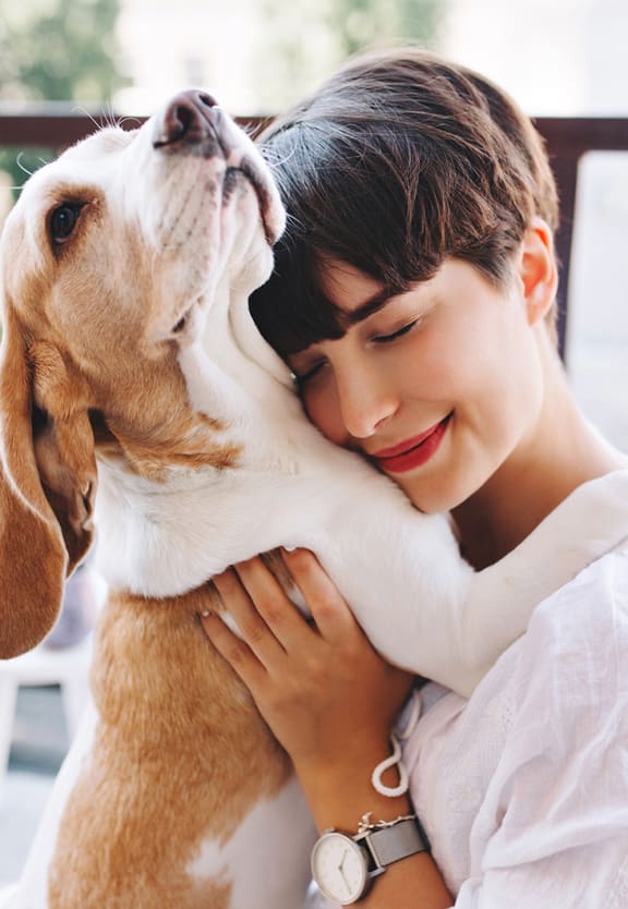 a woman hugging her dog