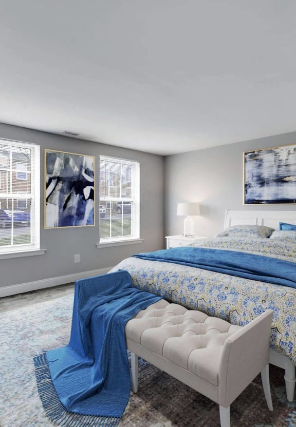 a bedroom with a bed and two windows