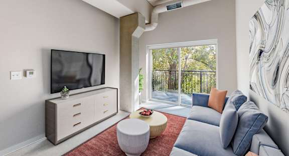 A modern living room with a television, sofas, and a balcony at Ardor on the Bluffs South Loop Residences Apartments, Minnesota, 55425
