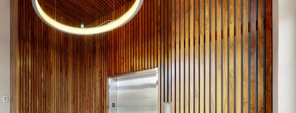 a view of a hallway with a door to a locker room and a lockers