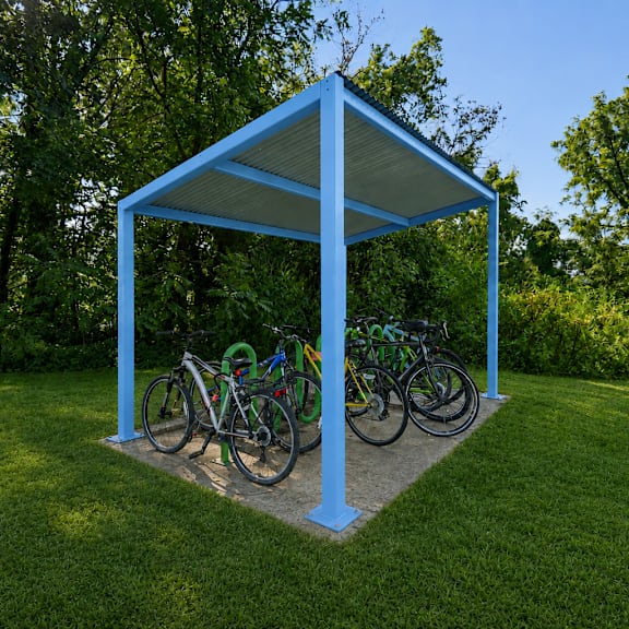 A blue structure with bicycles parked underneath it.