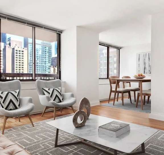 A modern living room with a view of the city. at The Ellington Apartments, New York