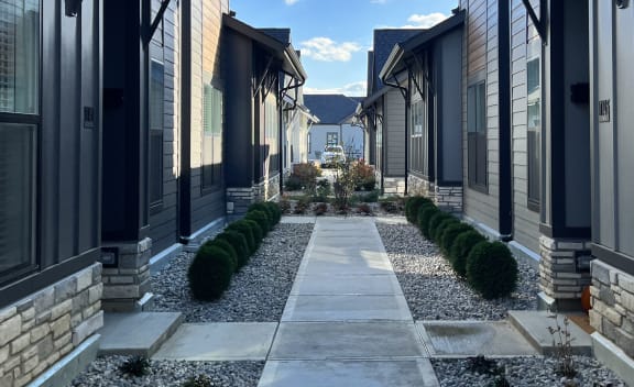 a walkway between two houses at Slate at Fishers District, Fishers, 46037
