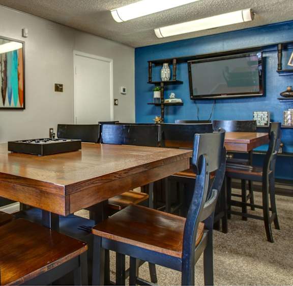 A dining room with a wooden table and chairs.