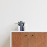 a dresser and a plant in a room