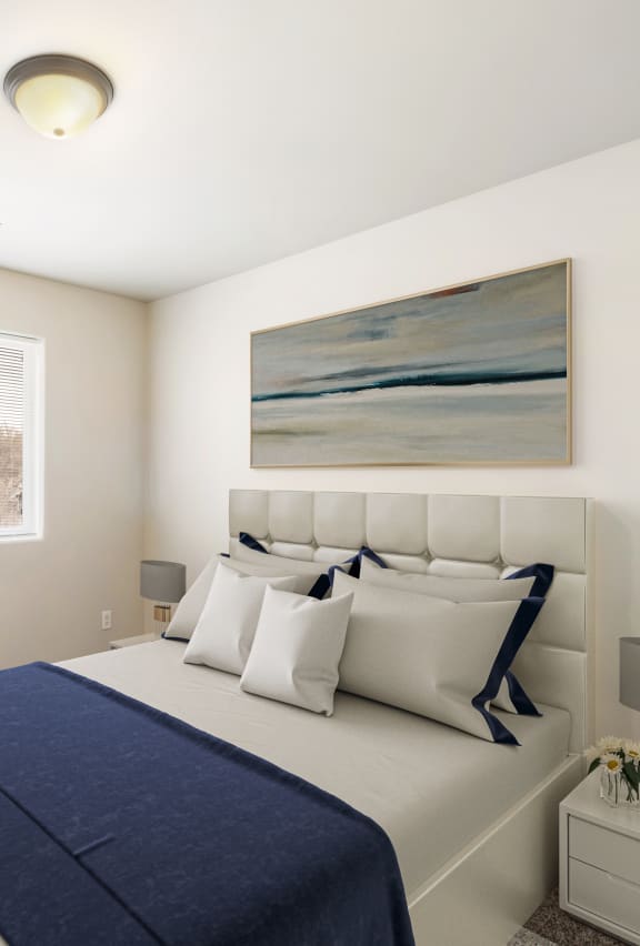 furnished bedroom with a bed and plant in the corner of the room at Pine Tree Park Apartments in Kennewick WA at Pine Tree Park, Kennewick, 99337