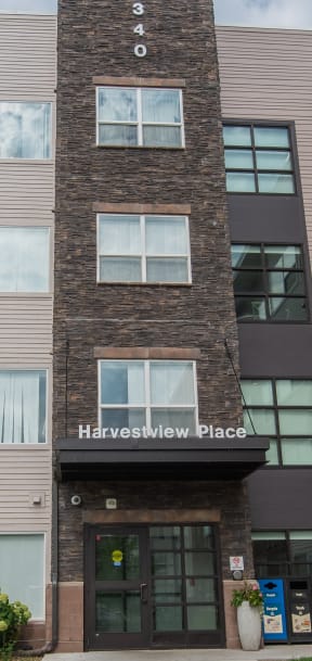an apartment building with a sidewalk in front of it