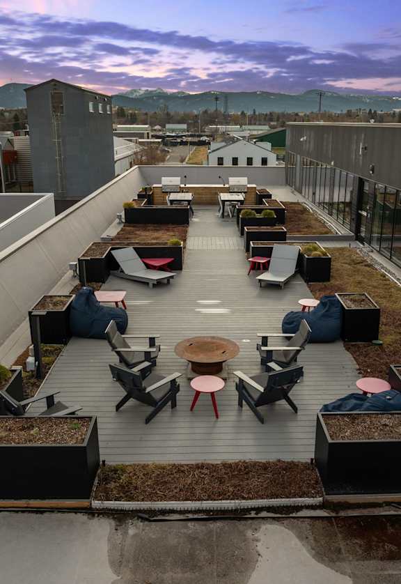 Rooftop patio with tables and chairs at Cannery Flats, Bozeman, MT, 59715