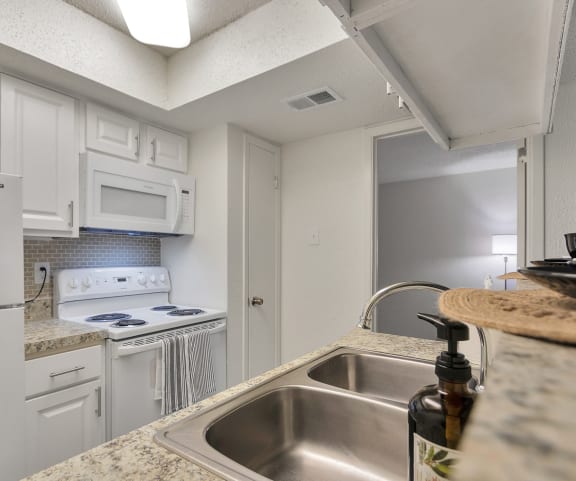 This is a photo of the kitchen of a 1245 square foot 2 bedroom apartment at Cambridge Court Apartments in Dallas, TX.