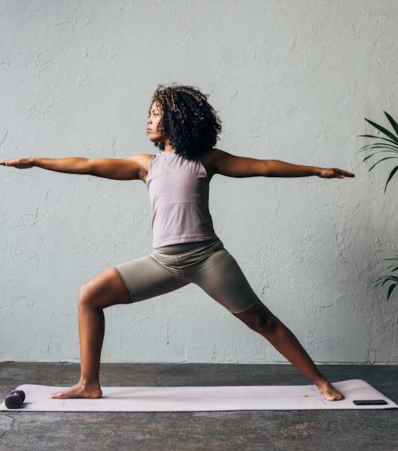 a woman doing a yoga pose on a yoga mat
