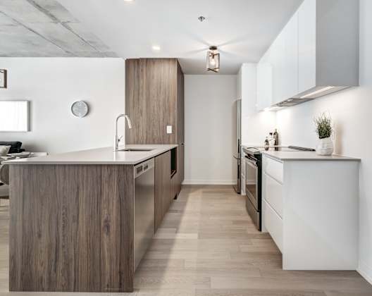 A modern kitchen with a wooden island and stainless steel appliances.