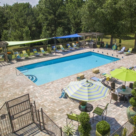 a swimming pool with umbrellas and chairs around it