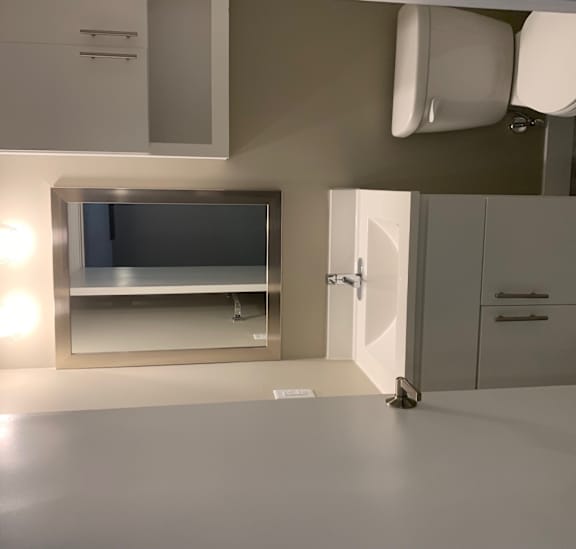 a kitchen with a sink and a refrigerator and a tv