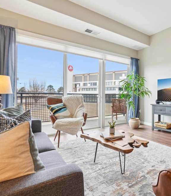 A living room with a brown leather couch and a wooden coffee table.