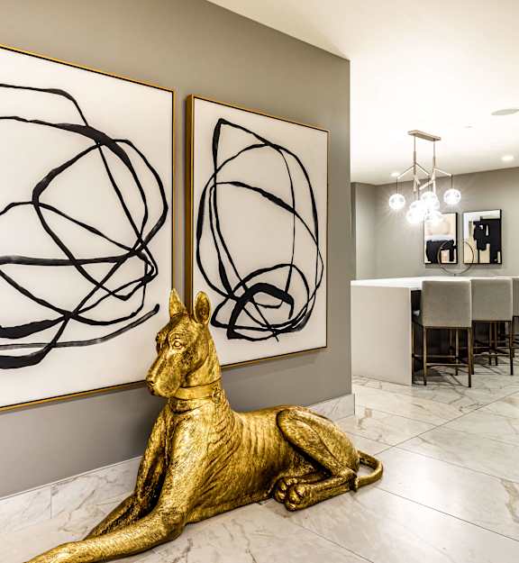 a room with two paintings and a statue of a dog  at The Grand, Kansas City