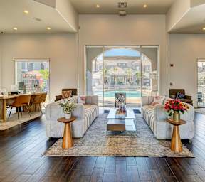 A living room with a large window and a view of the city.
