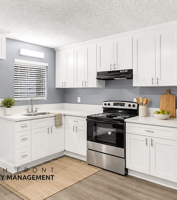 A well-lit, modern kitchen and living room with a dining area.