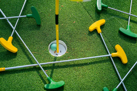 a golfer about to hit a golf ball at Staples Mill Townhomes, Richmond, VA